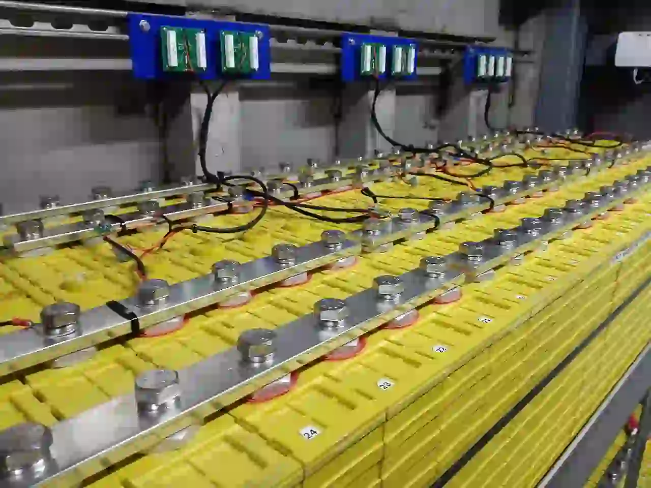Lithium iron phosphate cells and busbars Rows of lithium iron phosphate cells connected with metal busbars