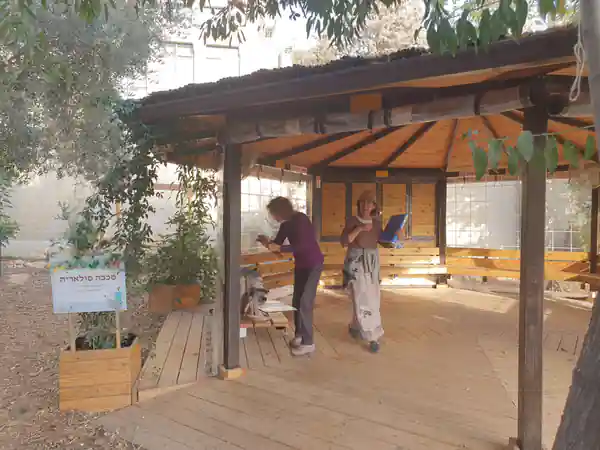 Roof-mounted solar panel array and mounting frame on an outbuilding shed structure